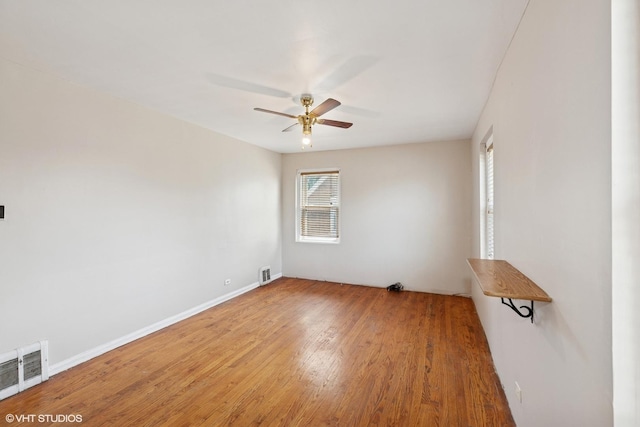 1242 E 98th St, Chicago, IL 60628 - spare room with ceiling fan, wood finished floors, and baseboards