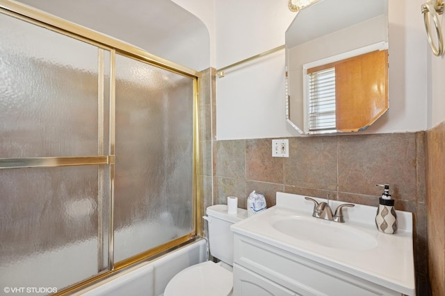 1242 E 98th St, Chicago, IL 60628 - full bath featuring tile walls, vanity, bath / shower combo with glass door, and toilet