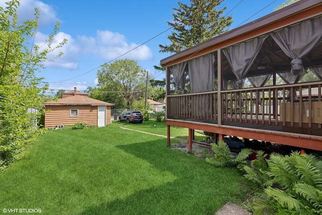 1242 E 98th St, Chicago, IL 60628 - view of green lawn featuring a wooden deck and a sunroom