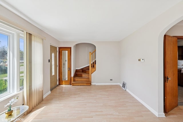 1242 E 98th St, Chicago, IL 60628 - entrance foyer featuring light wood-style flooring, plenty of natural light, arched walkways, and baseboards
