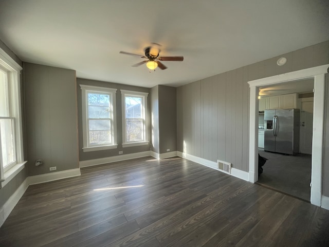 unfurnished room featuring ceiling fan and dark hardwood / wood-style flooring