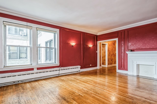 unfurnished living room featuring light wood-type flooring, a baseboard radiator, and crown molding