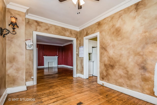 spare room featuring hardwood / wood-style floors, ceiling fan, and crown molding