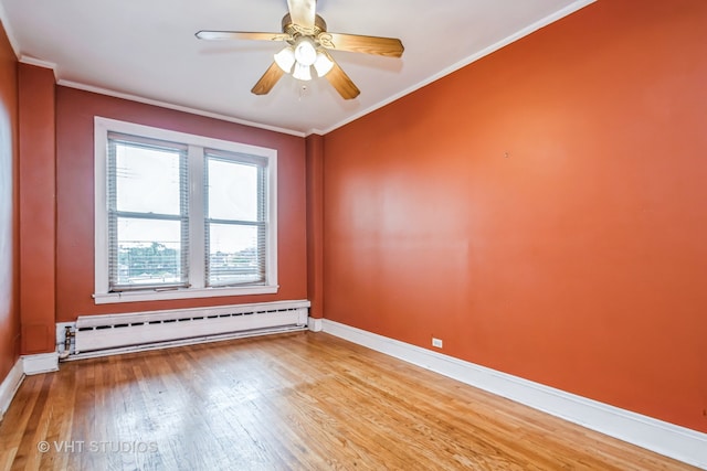 empty room featuring hardwood / wood-style floors, ceiling fan, a baseboard radiator, and crown molding