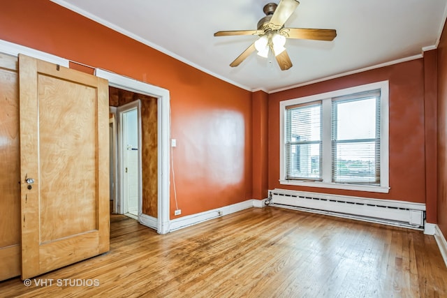 unfurnished room featuring baseboard heating, light hardwood / wood-style floors, ceiling fan, and crown molding