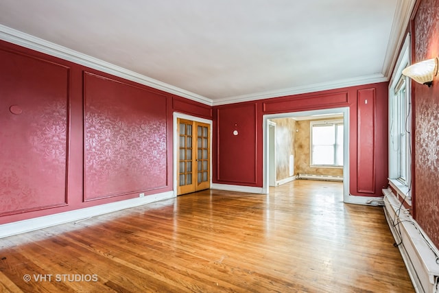 interior space featuring light hardwood / wood-style floors, baseboard heating, and crown molding