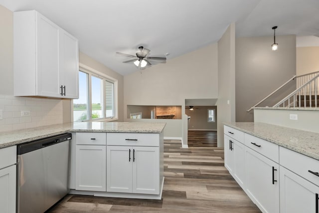 kitchen with ceiling fan, dishwasher, a peninsula, and vaulted ceiling