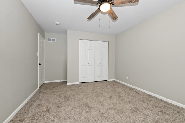 unfurnished bedroom with a closet, light carpet, and ceiling fan