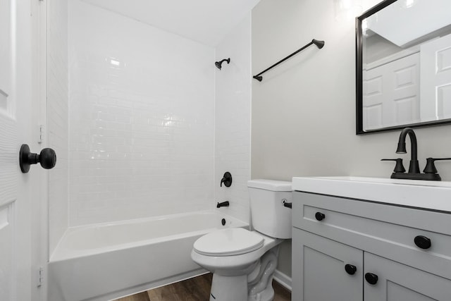 full bath with vanity,  shower combination, toilet, and wood finished floors