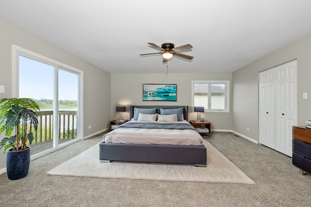 bedroom featuring baseboards, multiple windows, carpet floors, and access to outside