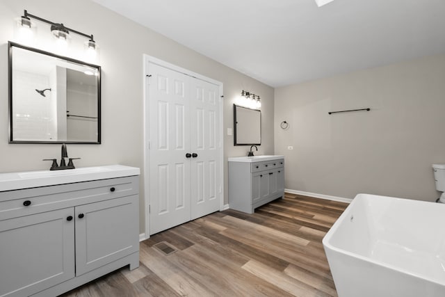 bathroom with vanity, hardwood / wood-style flooring, and separate shower and tub