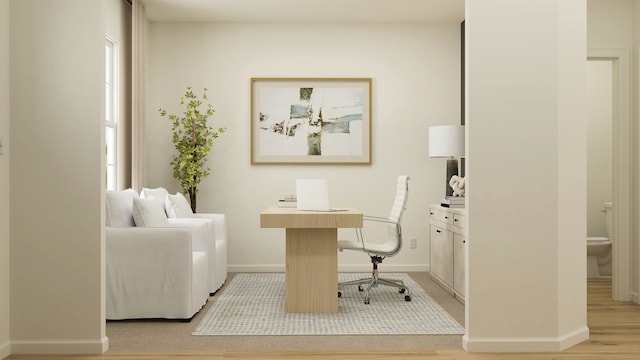 home office with light wood-type flooring and a wealth of natural light