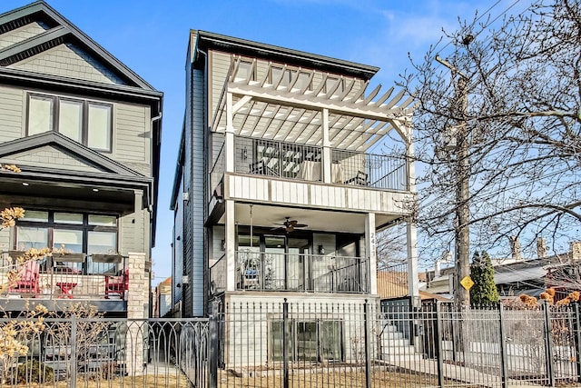 view of front of property featuring ceiling fan and a balcony