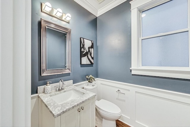 bathroom featuring crown molding, vanity, and toilet