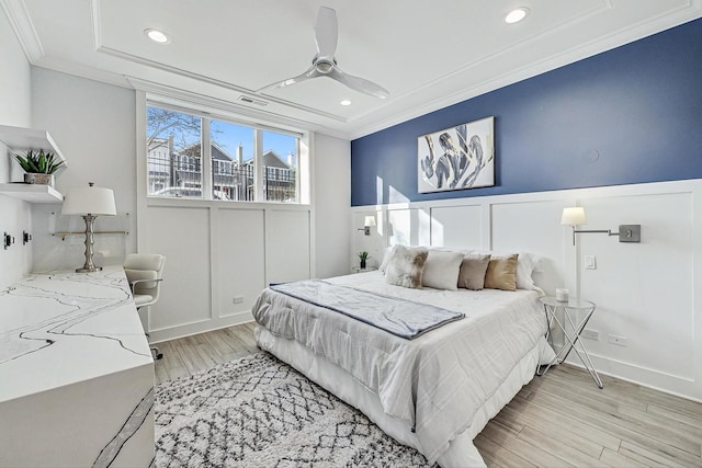 bedroom featuring crown molding, ceiling fan, and light hardwood / wood-style flooring