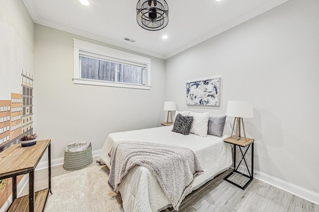 bedroom featuring hardwood / wood-style flooring and ornamental molding