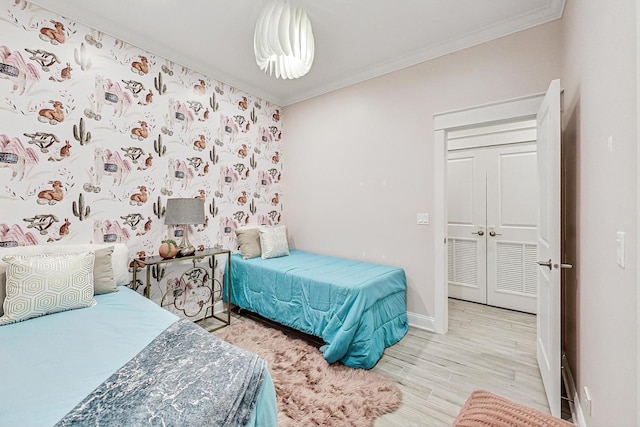 bedroom featuring crown molding and light wood-type flooring