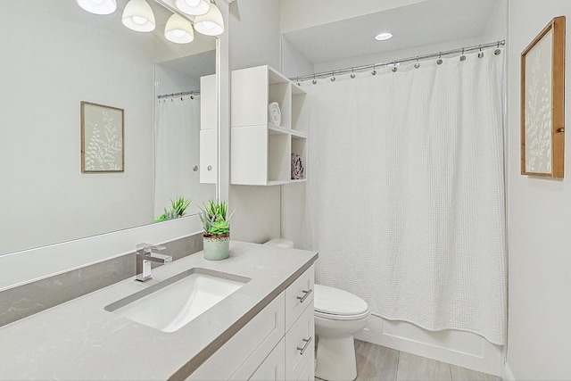 full bathroom featuring shower / bath combination with curtain, vanity, and toilet