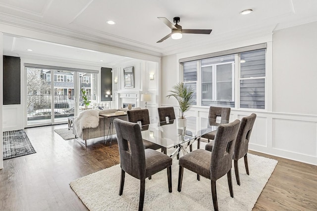 dining space featuring hardwood / wood-style flooring, crown molding, and ceiling fan