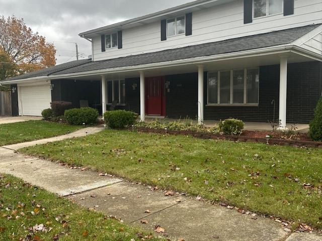 country-style home with a garage, covered porch, and a front lawn