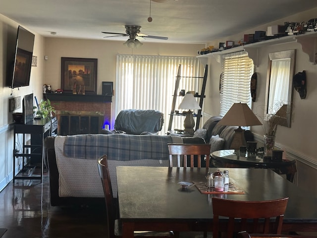 dining area with ceiling fan and dark wood-type flooring