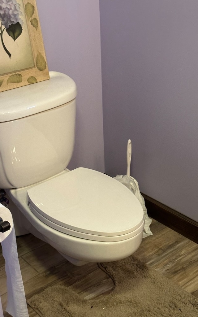 bathroom featuring hardwood / wood-style flooring and toilet