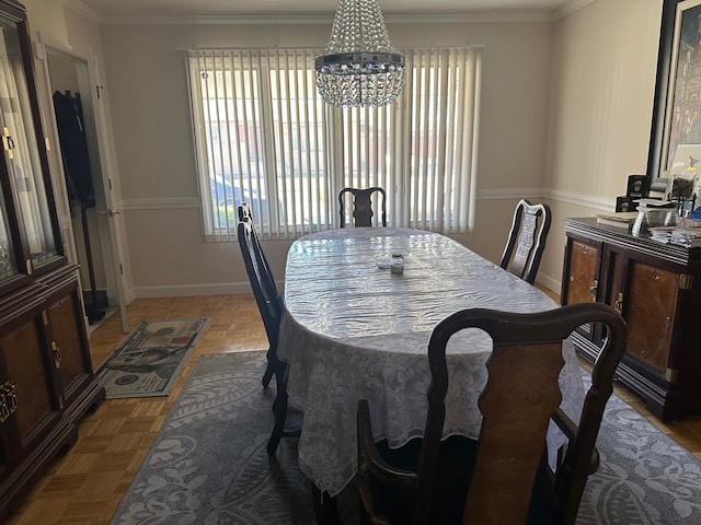 dining area featuring a notable chandelier, parquet flooring, and ornamental molding