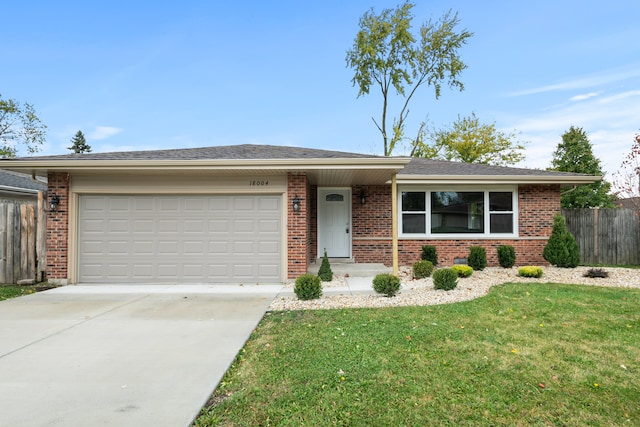 single story home featuring a front yard and a garage