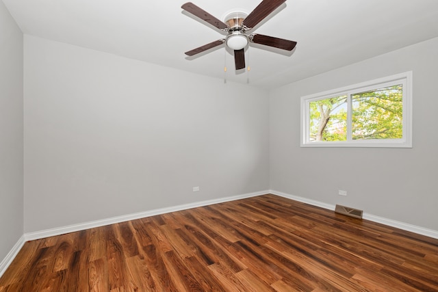 spare room featuring ceiling fan and dark wood-type flooring