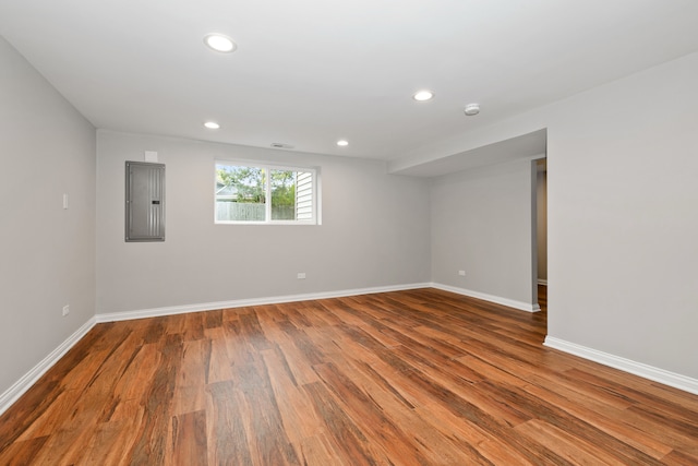 unfurnished room with hardwood / wood-style floors and electric panel