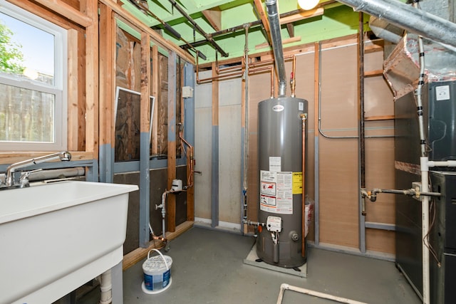 utilities featuring sink, heating unit, and water heater