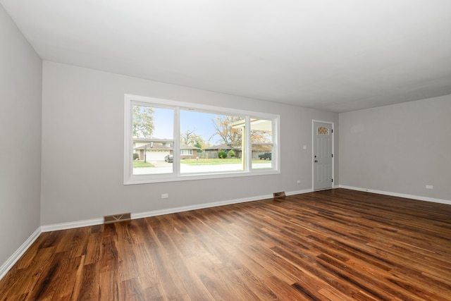 unfurnished room with dark hardwood / wood-style floors