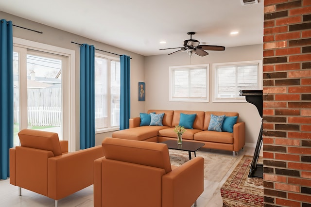 living room with plenty of natural light and ceiling fan