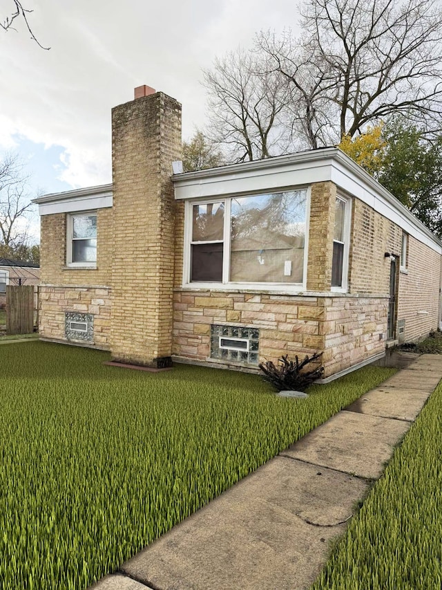 view of side of property with a lawn