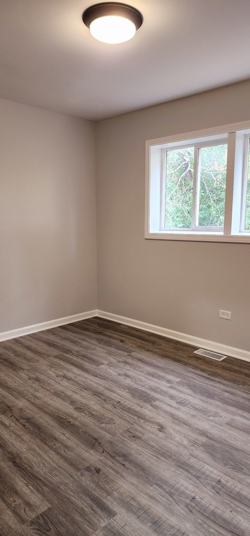 spare room featuring dark hardwood / wood-style floors