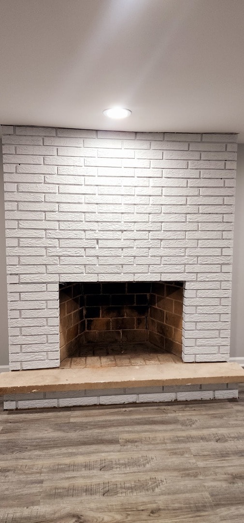 room details featuring hardwood / wood-style floors and a brick fireplace