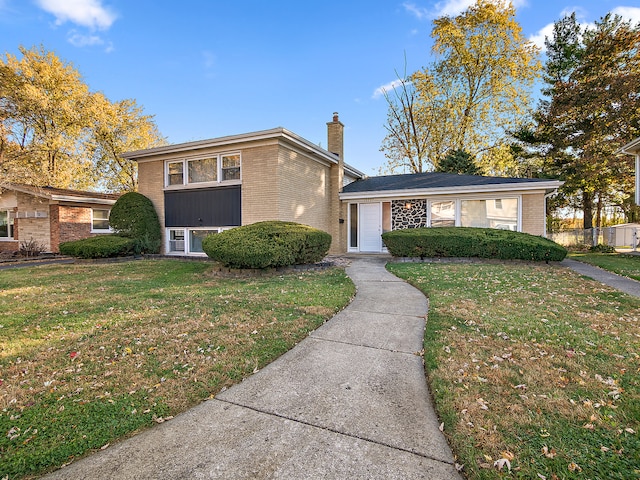 split level home featuring a front lawn