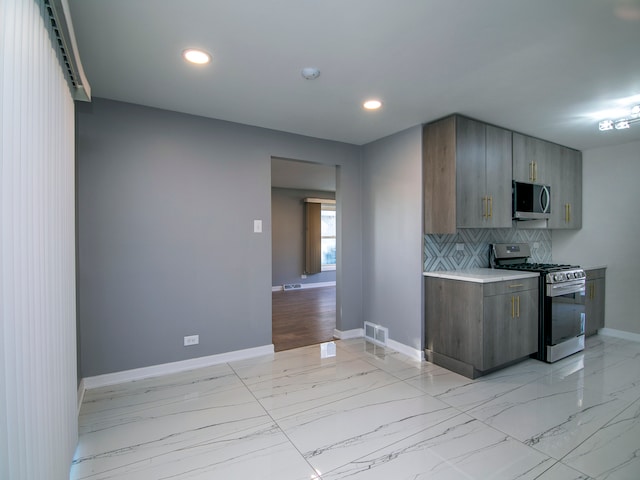 kitchen with tasteful backsplash and stainless steel appliances