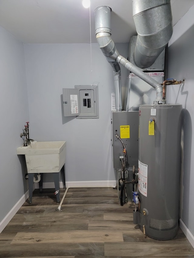 utility room featuring electric panel and water heater