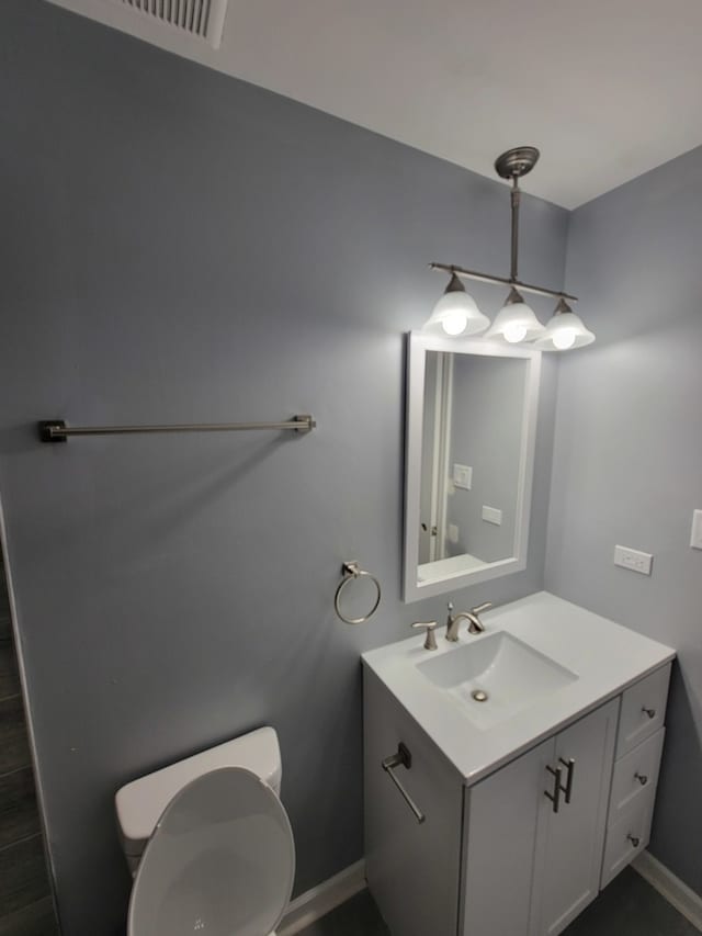 bathroom featuring vanity and toilet