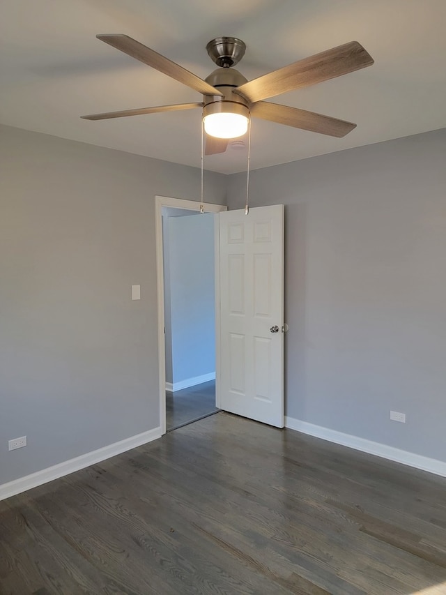 unfurnished room with dark hardwood / wood-style flooring and ceiling fan