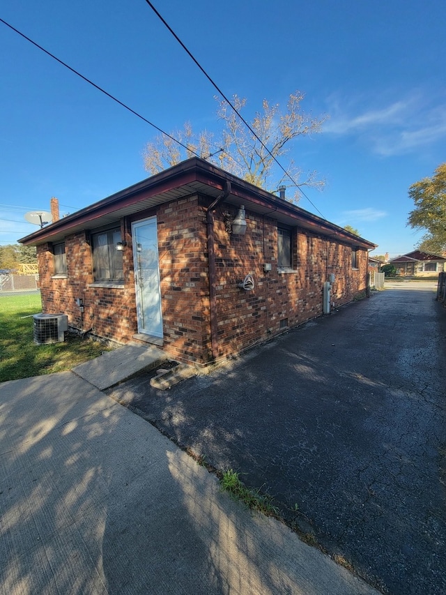 view of side of home featuring central AC