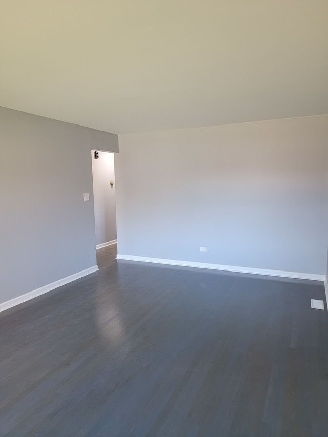 empty room featuring dark wood-type flooring