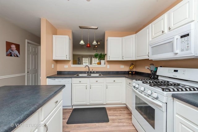 kitchen with sink, white cabinets, and white appliances