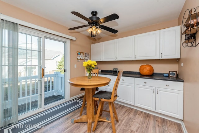 dining area with ceiling fan and light wood-type flooring