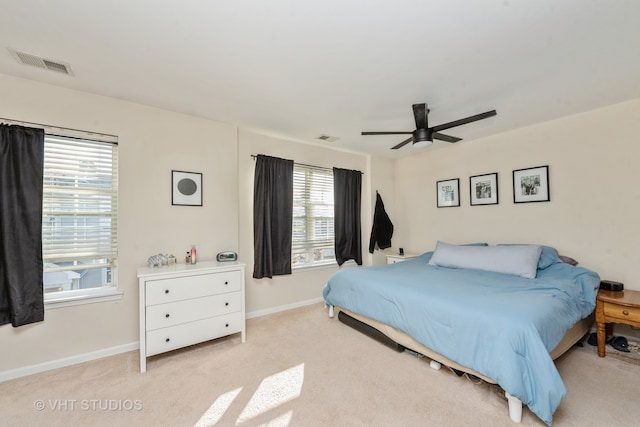 bedroom with ceiling fan and light carpet