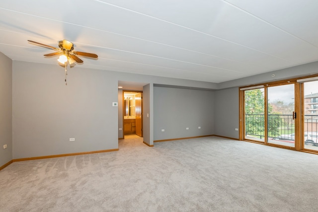 empty room featuring light carpet and ceiling fan