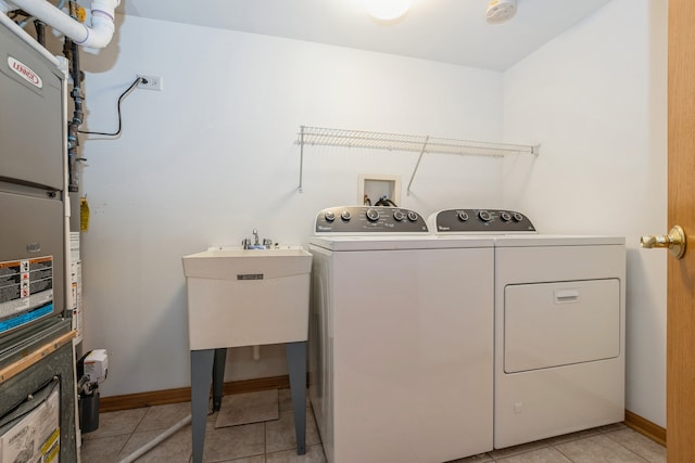 laundry room featuring sink, independent washer and dryer, and light tile patterned floors