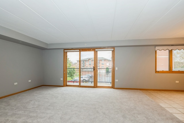 spare room with plenty of natural light and light carpet