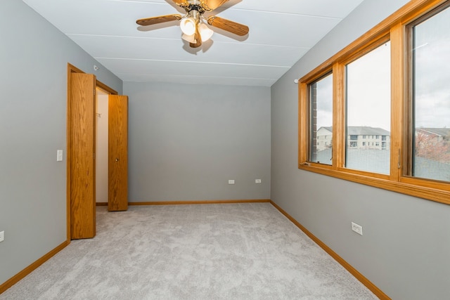 carpeted empty room with ceiling fan